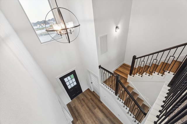 390 Kendall Crest Dr, Alvin, TX 77511 - foyer entrance with a high ceiling, a chandelier, stairs, and dark wood-style flooring