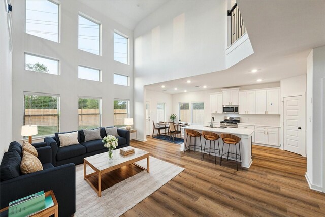 390 Kendall Crest Dr, Alvin, TX 77511 - living area with a high ceiling, healthy amount of natural light, wood finished floors, and recessed lighting