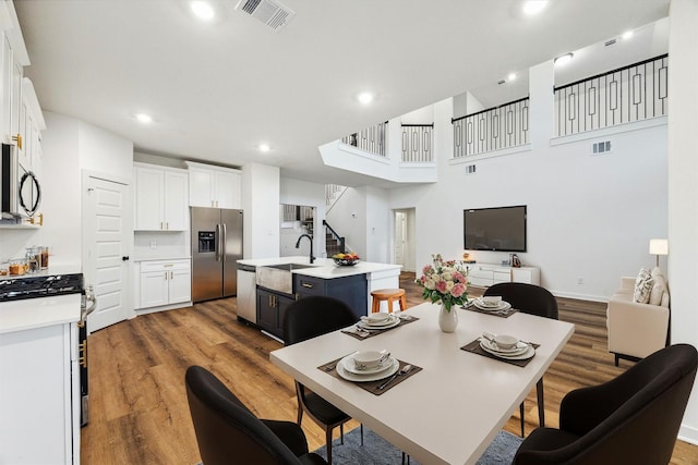 390 Kendall Crest Dr, Alvin, TX 77511 - dining area featuring wood finished floors, recessed lighting, and stairs