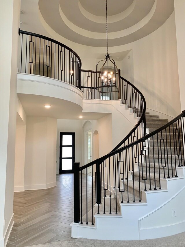 12515 Tullich Run Dr, Humble, TX 77346 - stairway with a towering ceiling, a chandelier, and arched walkways