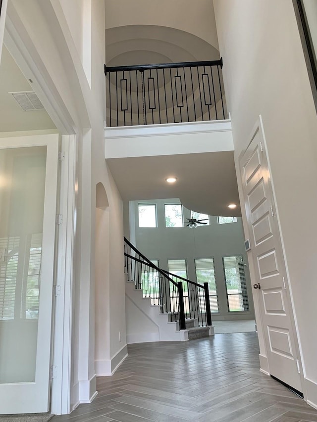 12515 Tullich Run Dr, Humble, TX 77346 - stairway with a high ceiling, a ceiling fan, and wood finished floors
