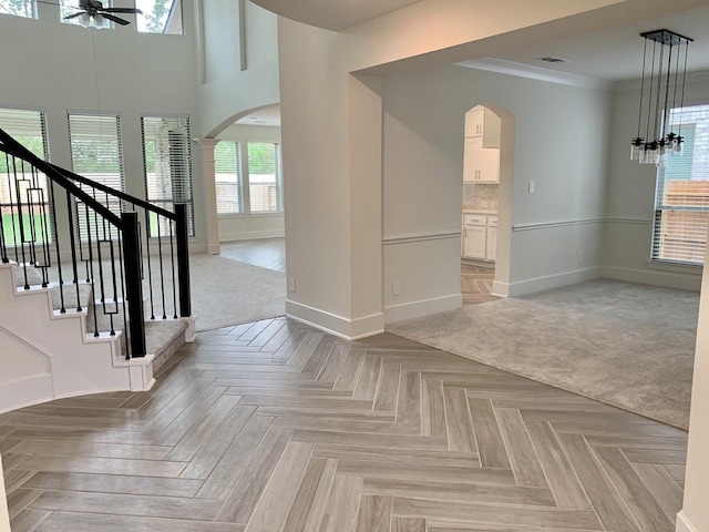12515 Tullich Run Dr, Humble, TX 77346 - foyer featuring arched walkways, ceiling fan, stairway, and crown molding