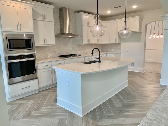 12515 Tullich Run Dr, Humble, TX 77346 - kitchen with wall chimney exhaust hood, stainless steel appliances, recessed lighting, and white cabinets