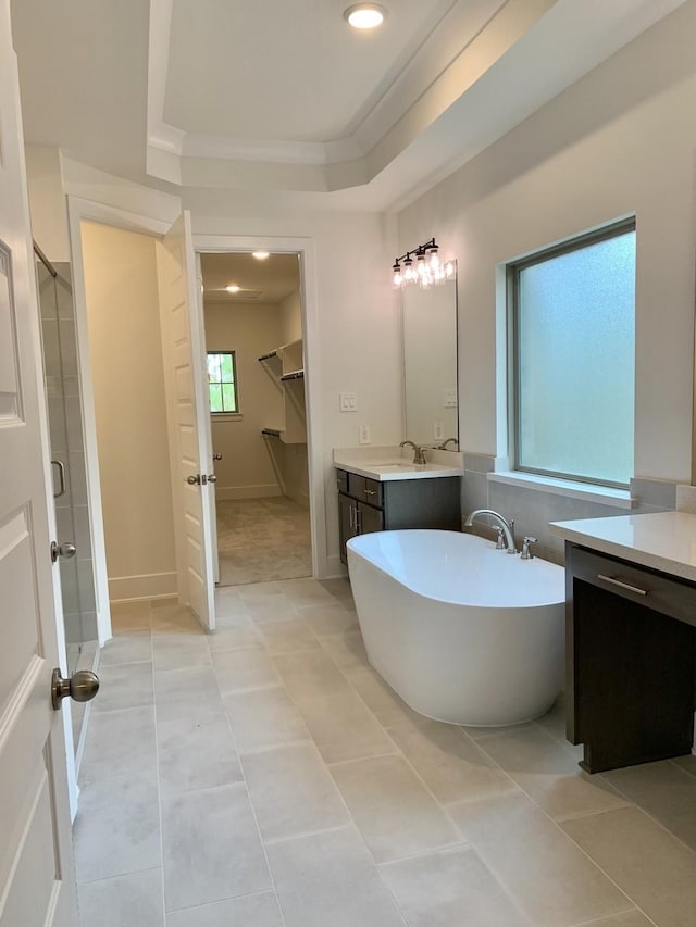 12515 Tullich Run Dr, Humble, TX 77346 - full bathroom with vanity, a freestanding bath, a shower stall, tile patterned floors, and a raised ceiling