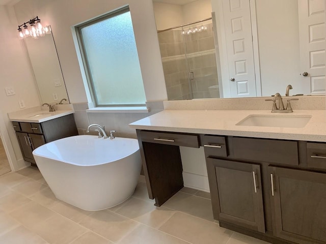 12515 Tullich Run Dr, Humble, TX 77346 - full bathroom featuring vanity, a shower stall, a freestanding tub, and tile patterned floors