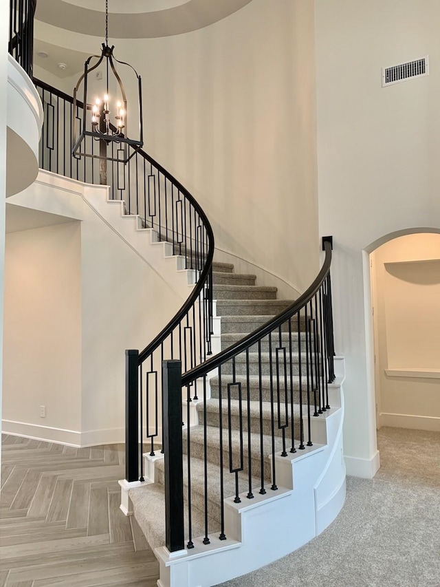 12515 Tullich Run Dr, Humble, TX 77346 - stairway with a chandelier, arched walkways, and a high ceiling