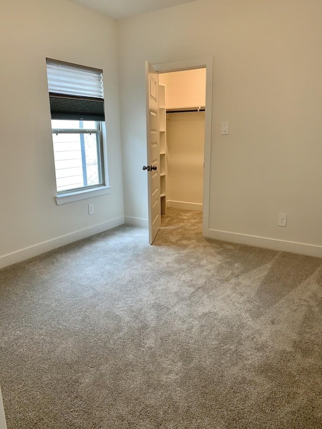 12515 Tullich Run Dr, Humble, TX 77346 - unfurnished bedroom with a walk in closet and carpet