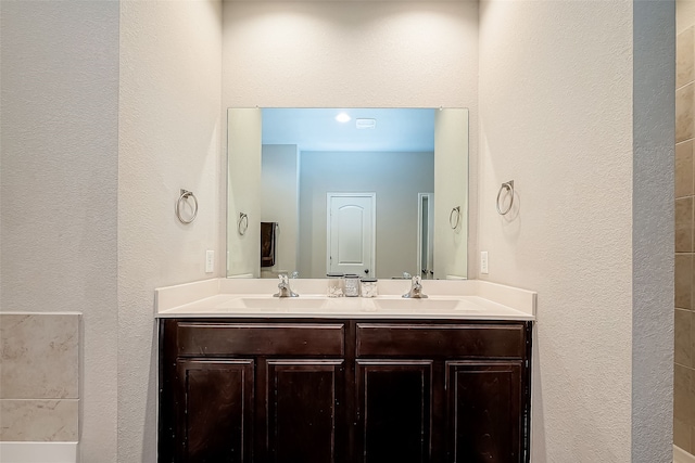 18623 Swainboro Dr, New Caney, TX 77357 - full bathroom featuring double vanity and a textured wall