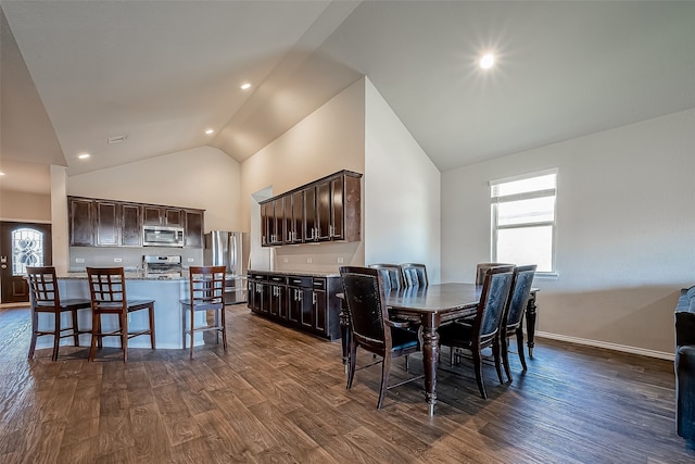 18623 Swainboro Dr, New Caney, TX 77357 - dining room with dark wood-style flooring, high vaulted ceiling, and recessed lighting