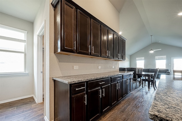 18623 Swainboro Dr, New Caney, TX 77357 - kitchen with lofted ceiling, dark wood-style floors, open floor plan, dark brown cabinets, and a ceiling fan