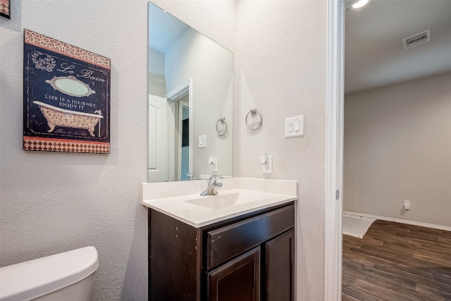 18623 Swainboro Dr, New Caney, TX 77357 - half bathroom with vanity, wood finished floors, and a textured wall