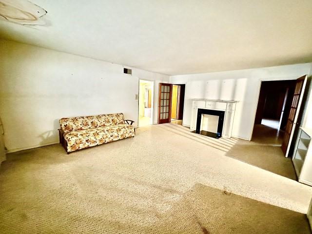 515 Vaky St, Corpus Christi, TX 78404 - unfurnished living room featuring a fireplace with flush hearth and carpet