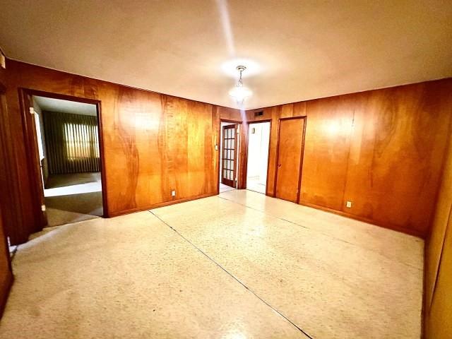 515 Vaky St, Corpus Christi, TX 78404 - unfurnished room featuring wooden walls and dark speckled floor