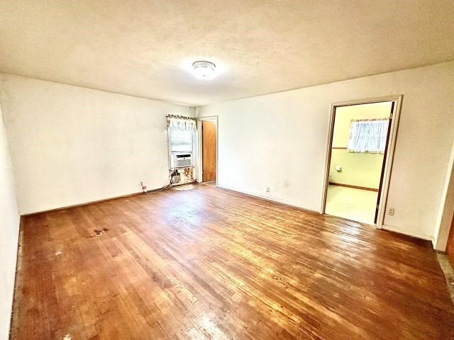515 Vaky St, Corpus Christi, TX 78404 - unfurnished room featuring wood finished floors and cooling unit