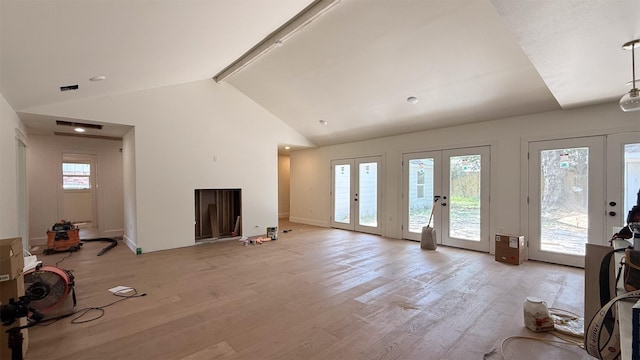 10047 Meadow Lake Ln, Houston, TX 77042 - unfurnished living room with french doors, beam ceiling, light wood-type flooring, and high vaulted ceiling