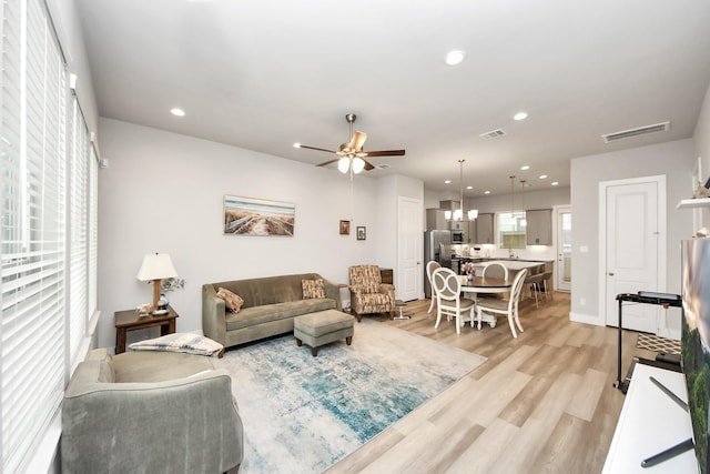 9016 Lonestar River Ln, Houston, TX 77080 - living area featuring ceiling fan, light wood-type flooring, recessed lighting, and a chandelier