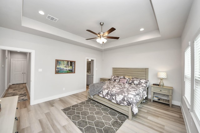 9016 Lonestar River Ln, Houston, TX 77080 - bedroom with a tray ceiling, light wood-style floors, recessed lighting, and a ceiling fan