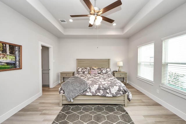 9016 Lonestar River Ln, Houston, TX 77080 - bedroom with a raised ceiling, light wood finished floors, recessed lighting, and a ceiling fan