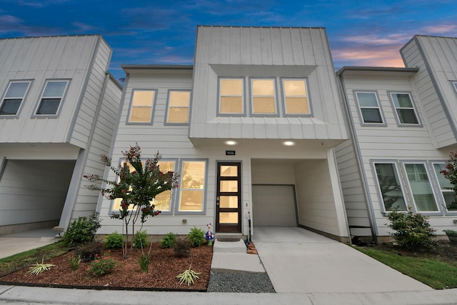 9016 Lonestar River Ln, Houston, TX 77080 - contemporary house with board and batten siding, a garage, and concrete driveway