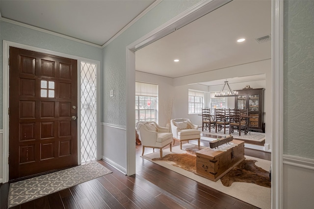 7634 Braesdale Ln, Houston, TX 77071 - entrance foyer featuring a textured wall, ornamental molding, wood finished floors, a chandelier, and wainscoting