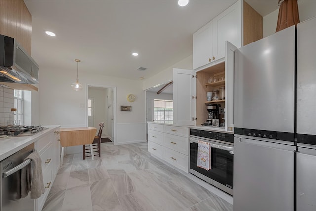 7634 Braesdale Ln, Houston, TX 77071 - kitchen featuring appliances with stainless steel finishes, white cabinets, recessed lighting, decorative light fixtures, and light countertops