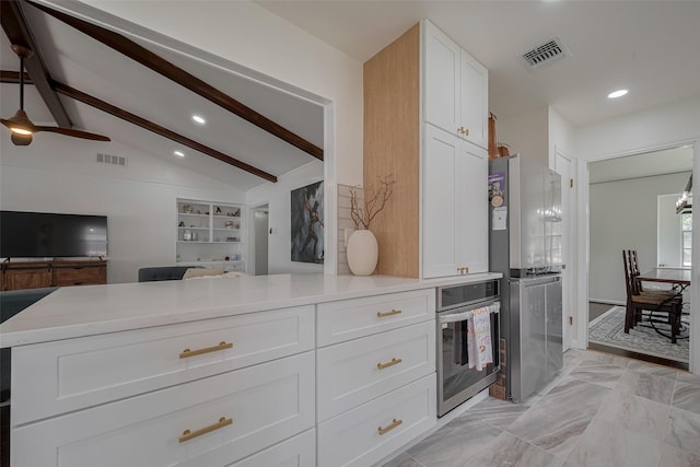 7634 Braesdale Ln, Houston, TX 77071 - kitchen with stainless steel oven, open floor plan, white cabinets, recessed lighting, and light countertops