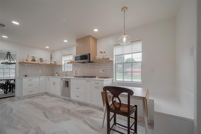 7634 Braesdale Ln, Houston, TX 77071 - kitchen featuring appliances with stainless steel finishes, open shelves, light countertops, tasteful backsplash, and pendant lighting