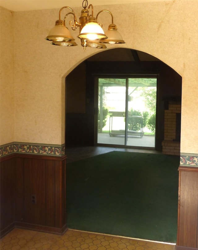 415 N Atchison St, Sealy, TX 77474 - unfurnished dining area with wainscoting and arched walkways