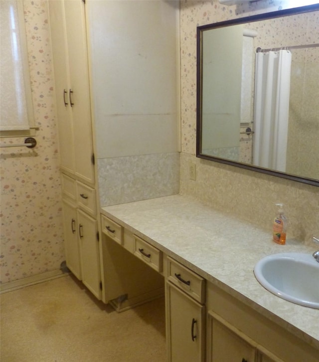 415 N Atchison St, Sealy, TX 77474 - bathroom with wallpapered walls, vanity, and backsplash