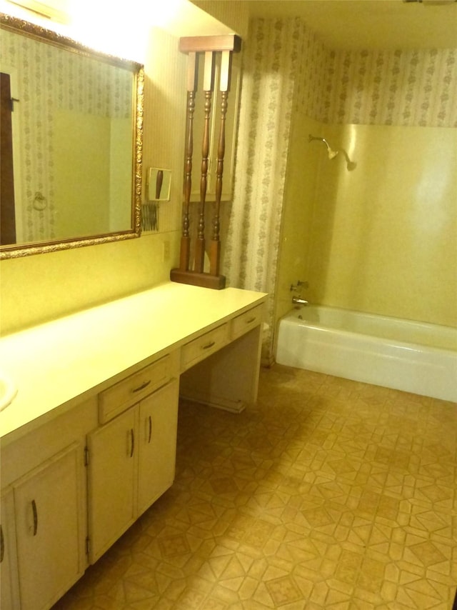 415 N Atchison St, Sealy, TX 77474 - bathroom featuring wallpapered walls, tile patterned floors, vanity, and washtub / shower combination