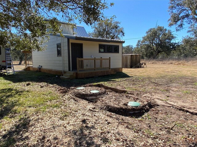 TRACT2 Private Road 648th St, Cedar Lake, TX 77414 - back of property with a metal roof and a lawn