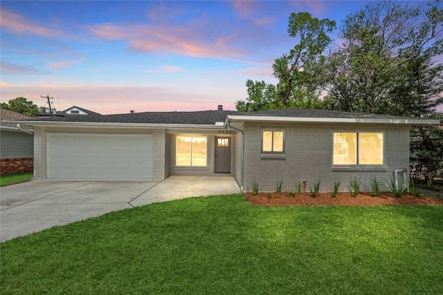 4406 Merwin St, Houston, TX 77027 - ranch-style home with a garage, concrete driveway, brick siding, and a lawn