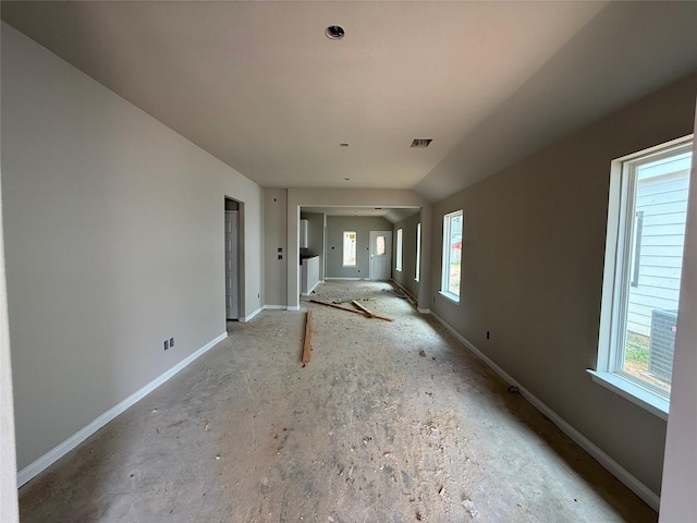 2541 Hawks Eye Dr, Conroe, TX 77301 - unfurnished living room with baseboards and lofted ceiling