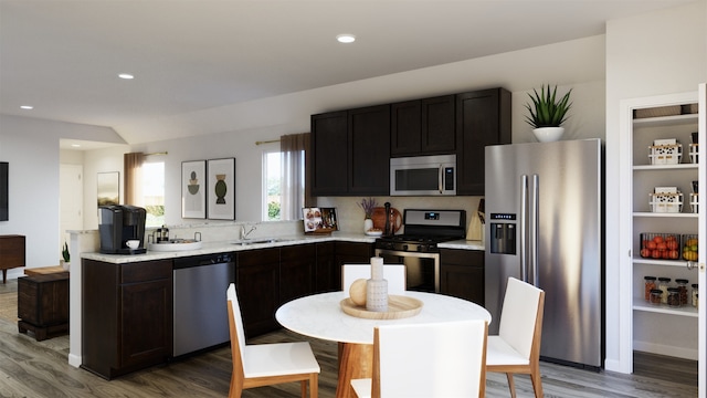 2528 Hawks Eye Dr, Conroe, TX 77301 - kitchen featuring appliances with stainless steel finishes, light wood-style floors, light countertops, and recessed lighting