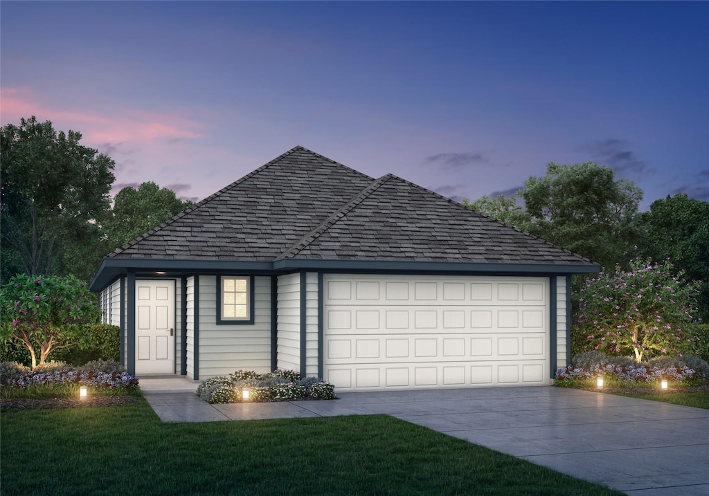 2544 Hawks Eye Dr, Conroe, TX 77301 - garage at dusk featuring driveway and a lawn