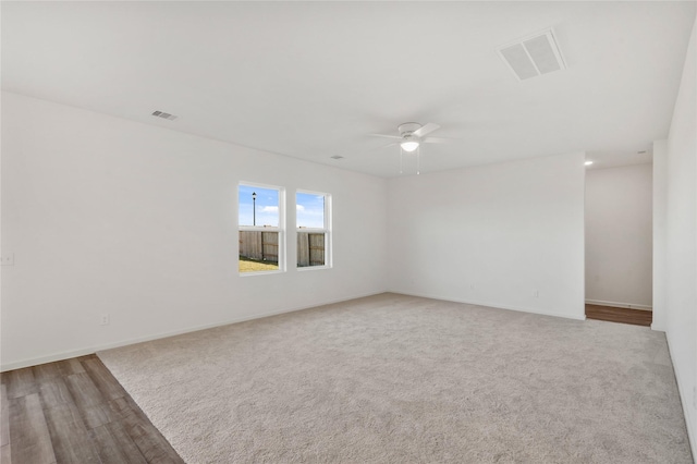 27214 Leeward Jetty Dr, Katy, TX 77493 - empty room with ceiling fan, carpet flooring, and wood finished floors