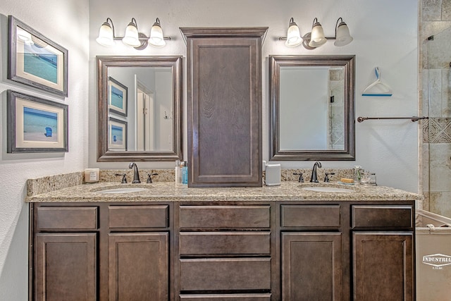 520 W 30th St, Houston, TX 77018 - full bath featuring double vanity, a tile shower, and a textured wall