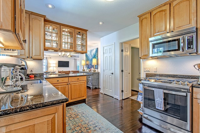 520 W 30th St, Houston, TX 77018 - kitchen with appliances with stainless steel finishes, dark wood-style floors, glass insert cabinets, a peninsula, and recessed lighting