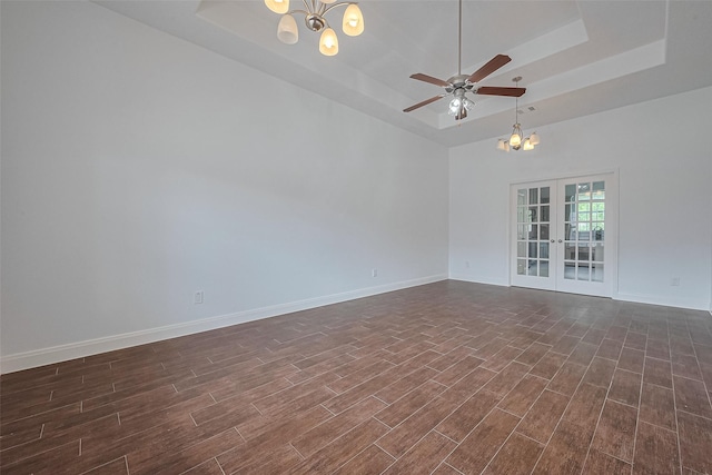 2403 Ranna Ct, Sugar Land, TX 77498 - unfurnished room featuring a chandelier, a tray ceiling, and dark wood-style floors
