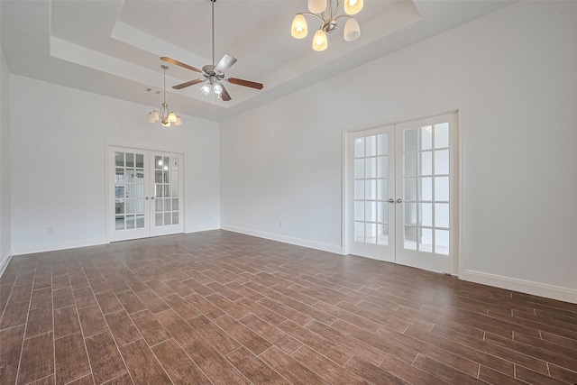 2403 Ranna Ct, Sugar Land, TX 77498 - spare room with french doors, a chandelier, a raised ceiling, and dark wood finished floors