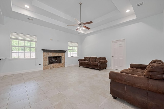 2403 Ranna Ct, Sugar Land, TX 77498 - living room with a raised ceiling, a ceiling fan, a high end fireplace, light tile patterned floors, and recessed lighting