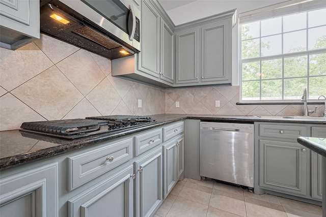 2403 Ranna Ct, Sugar Land, TX 77498 - kitchen featuring stainless steel appliances, gray cabinets, tasteful backsplash, and light tile patterned floors