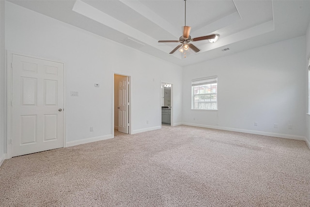 2403 Ranna Ct, Sugar Land, TX 77498 - unfurnished bedroom with light colored carpet, a raised ceiling, ensuite bath, and a ceiling fan