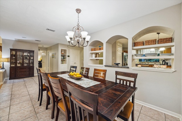 11 Leaf Trace Ct, Spring, TX 77381 - tiled dining space featuring a chandelier, arched walkways, and built in features