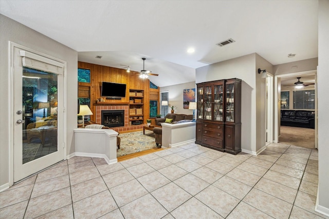 11 Leaf Trace Ct, Spring, TX 77381 - living room featuring ceiling fan, light tile patterned floors, a fireplace, wood walls, and vaulted ceiling