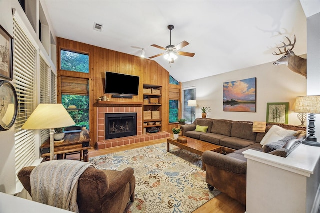11 Leaf Trace Ct, Spring, TX 77381 - living area with wooden walls, wood finished floors, vaulted ceiling, built in shelves, and a ceiling fan