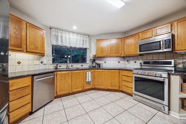 11 Leaf Trace Ct, Spring, TX 77381 - kitchen featuring appliances with stainless steel finishes, tasteful backsplash, light tile patterned floors, and recessed lighting