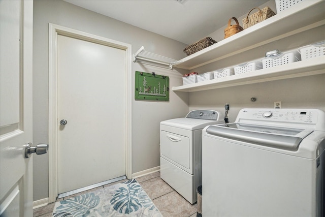 11 Leaf Trace Ct, Spring, TX 77381 - laundry area featuring washing machine and clothes dryer and light tile patterned floors