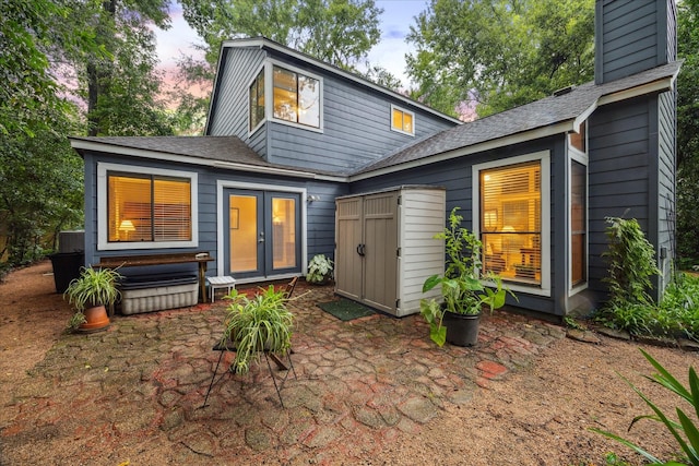 11 Leaf Trace Ct, Spring, TX 77381 - rear view of house with french doors, a patio, a chimney, and roof with shingles