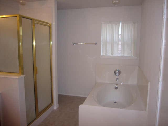 11514 Musetta Ct, Cypress, TX 77429 - bathroom featuring a shower stall, a bath, and tile patterned flooring